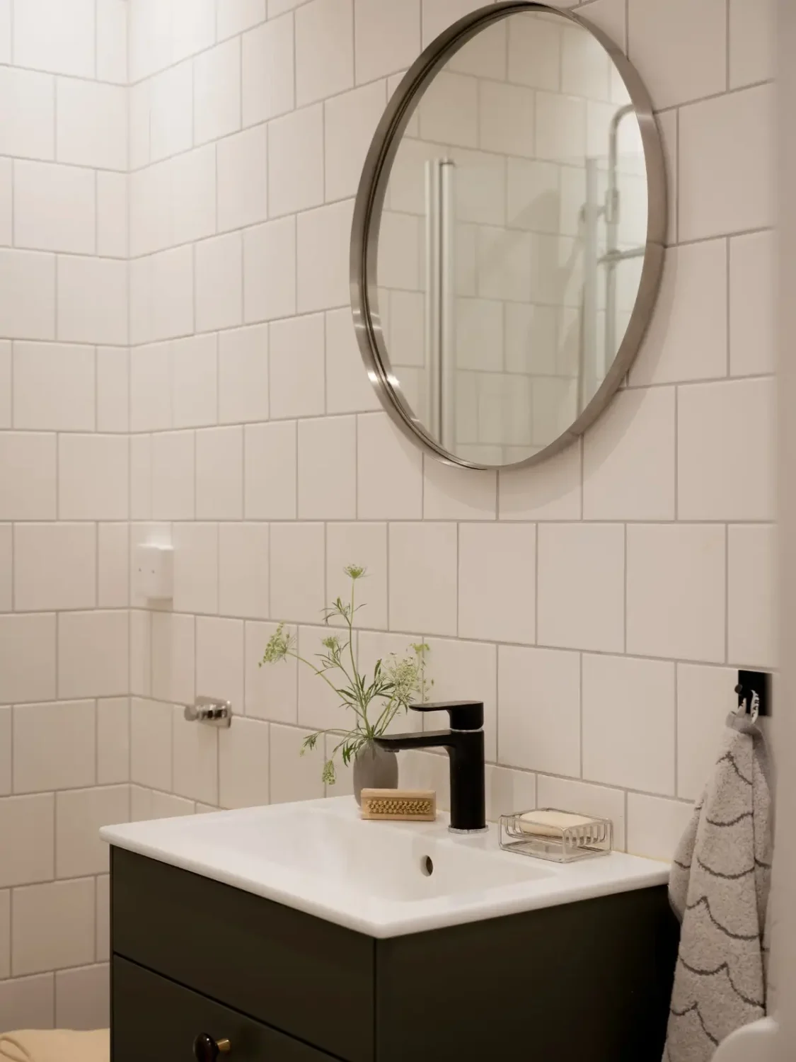 A Cozy Apartment with Exposed Brick and Period Details 29 bathroom round mirror