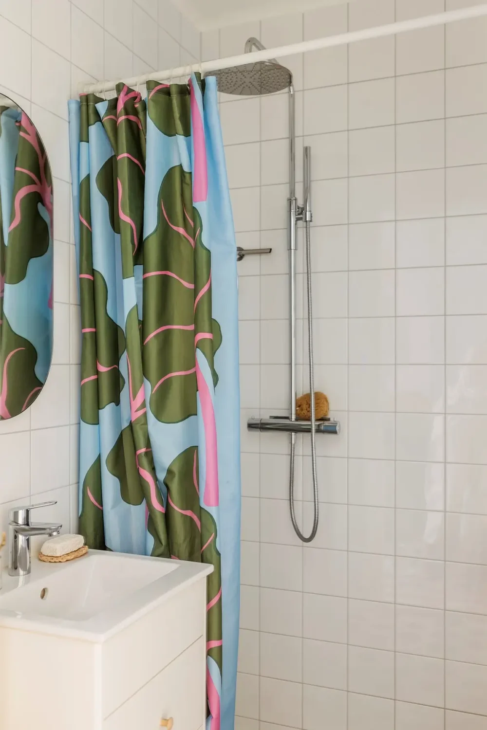 A Charming Swedish Courtyard Apartment Filled with Art 22 bathroom white tiles vanity