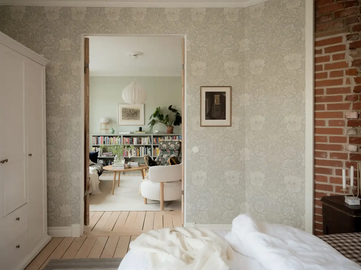 A Cozy Apartment with Exposed Brick and Period Details 15 bedroom floral wallpaper light wooden floor