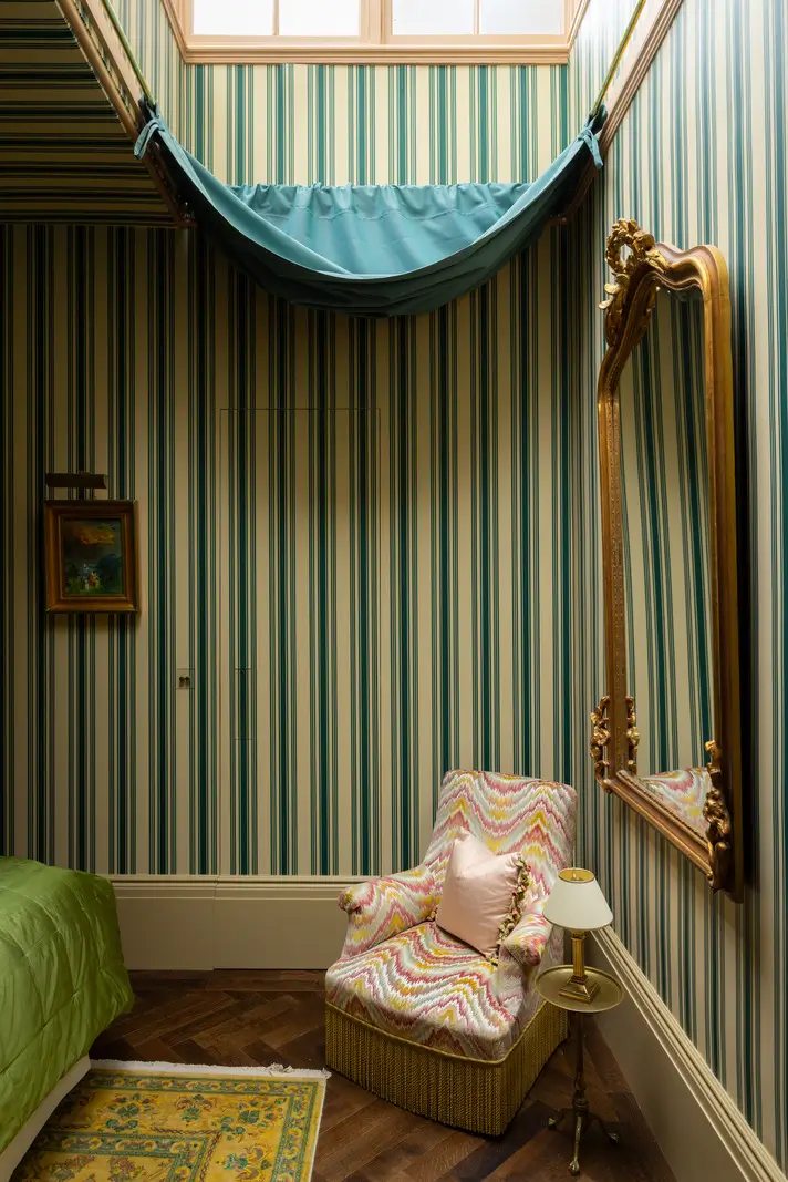 A Mixture of Patterns, Colors, and Materials in a Stunning London Apartment 20 bedroom striped wallpaper skylight with curtain nordroom