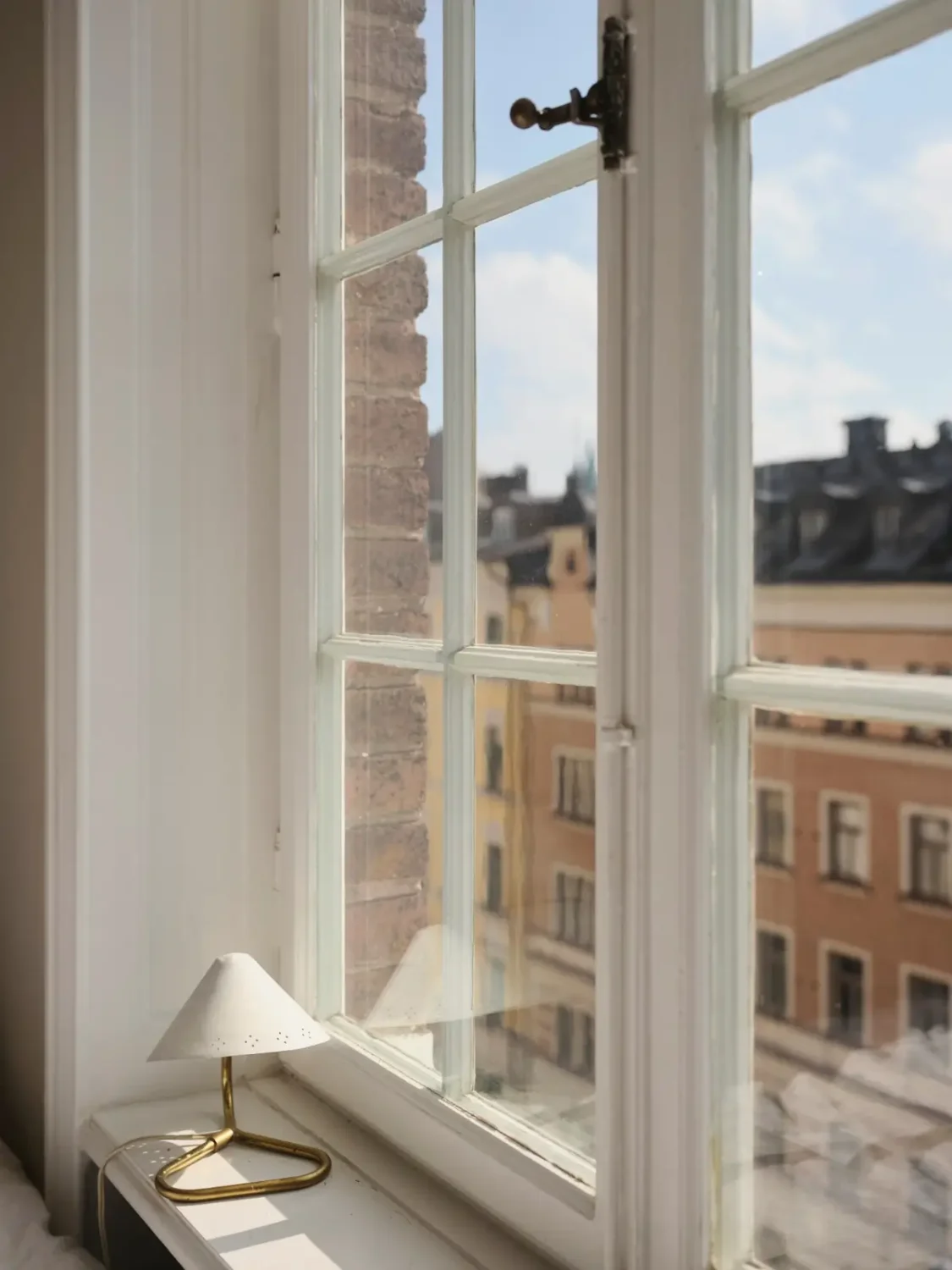Warm Pink Walls and a Glass Room Divider in a Small Stockholm Apartment 24 bedroom window