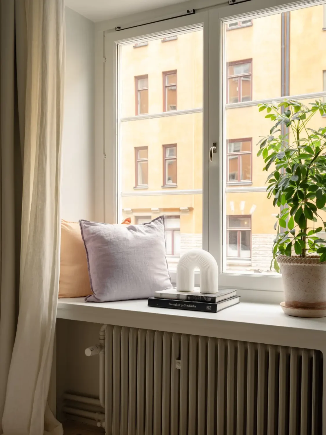 A Light Color Palette and a Charming Private Patio in a Stockholm Apartment 22 bedroom window