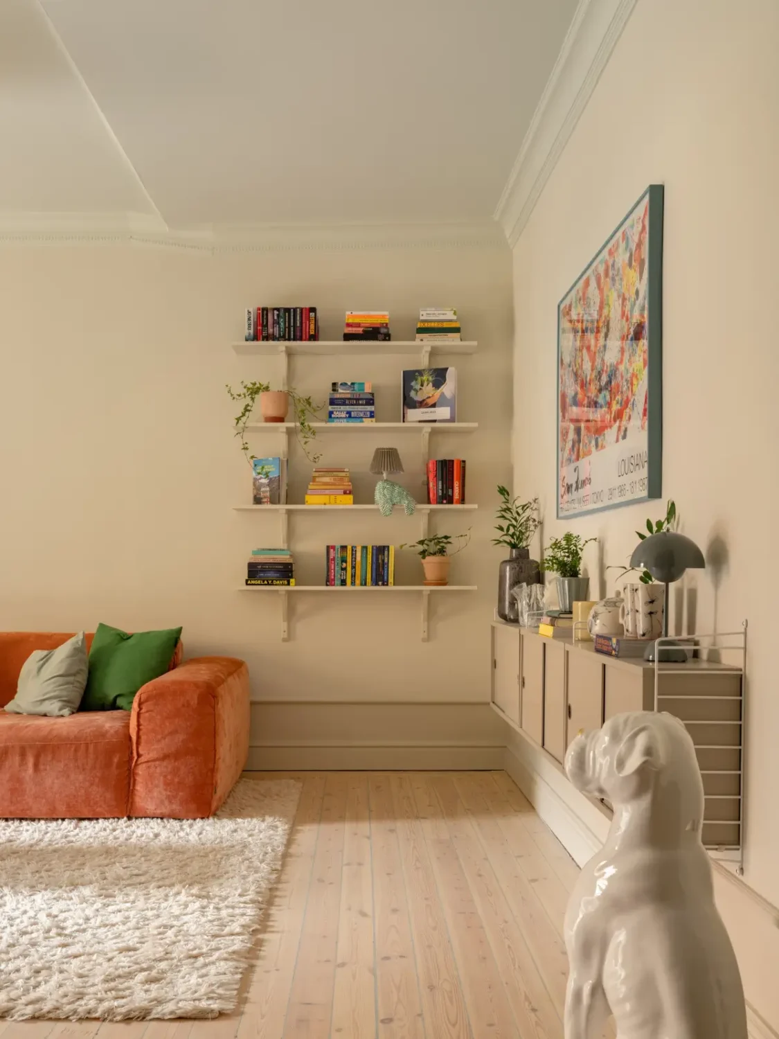 A Light Color Palette and a Charming Private Patio in a Stockholm Apartment 2 beige living room orange sofa