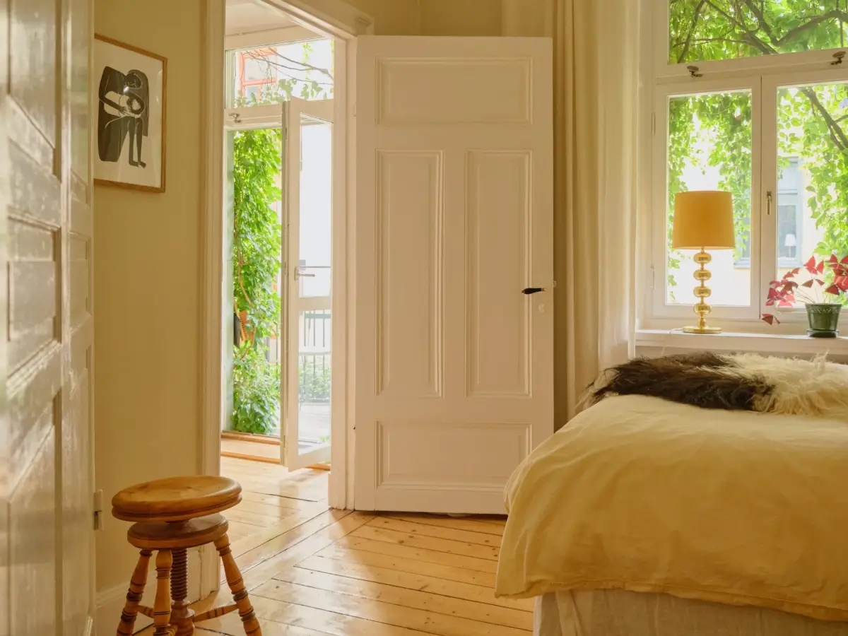 A Lush Balcony and Charming Rooms in a Late 19th Century Apartment 12 beige-yellow bedroom wooden floor