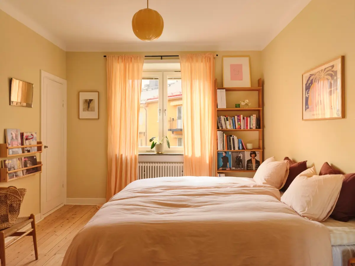 Soft Beige Interiors with the Occasional Bright Color Pop in Stockholm 19 beige-yellow bedroom wooden floor