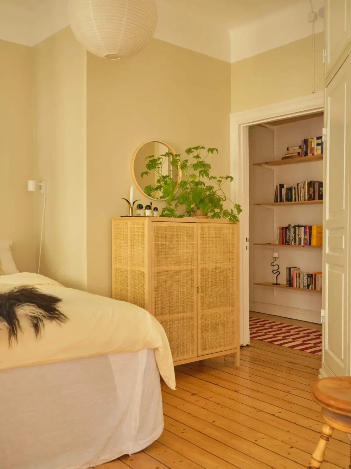 A Lush Balcony and Charming Rooms in a Late 19th Century Apartment 16 beige-yellow bedroom wooden floorboards ikea cabinet nordroom
