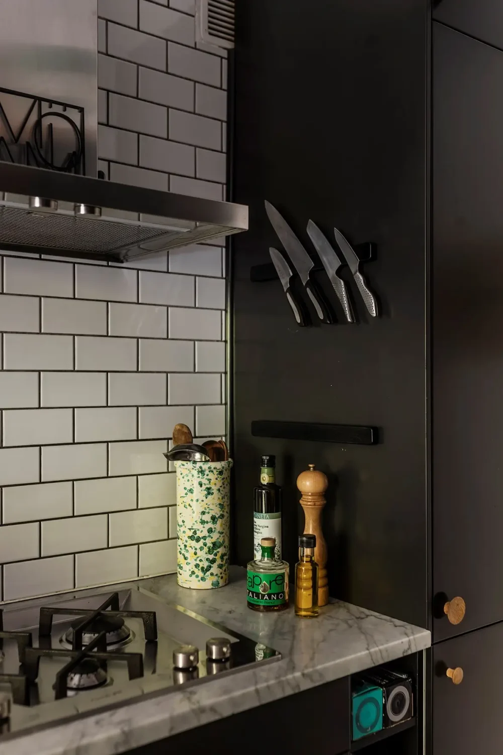 A Charming Swedish Courtyard Apartment Filled with Art 12 black kitchen detail