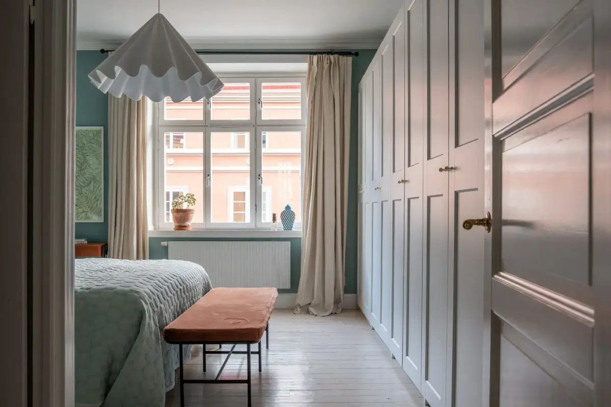 A Light Turn-of-the-Century Apartment with a Blue Kitchen 19 blue bedroom wardrobe wall
