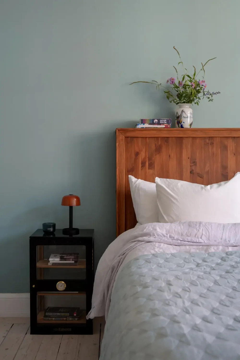 A Light Turn-of-the-Century Apartment with a Blue Kitchen 22 blue bedroom wooden headboard