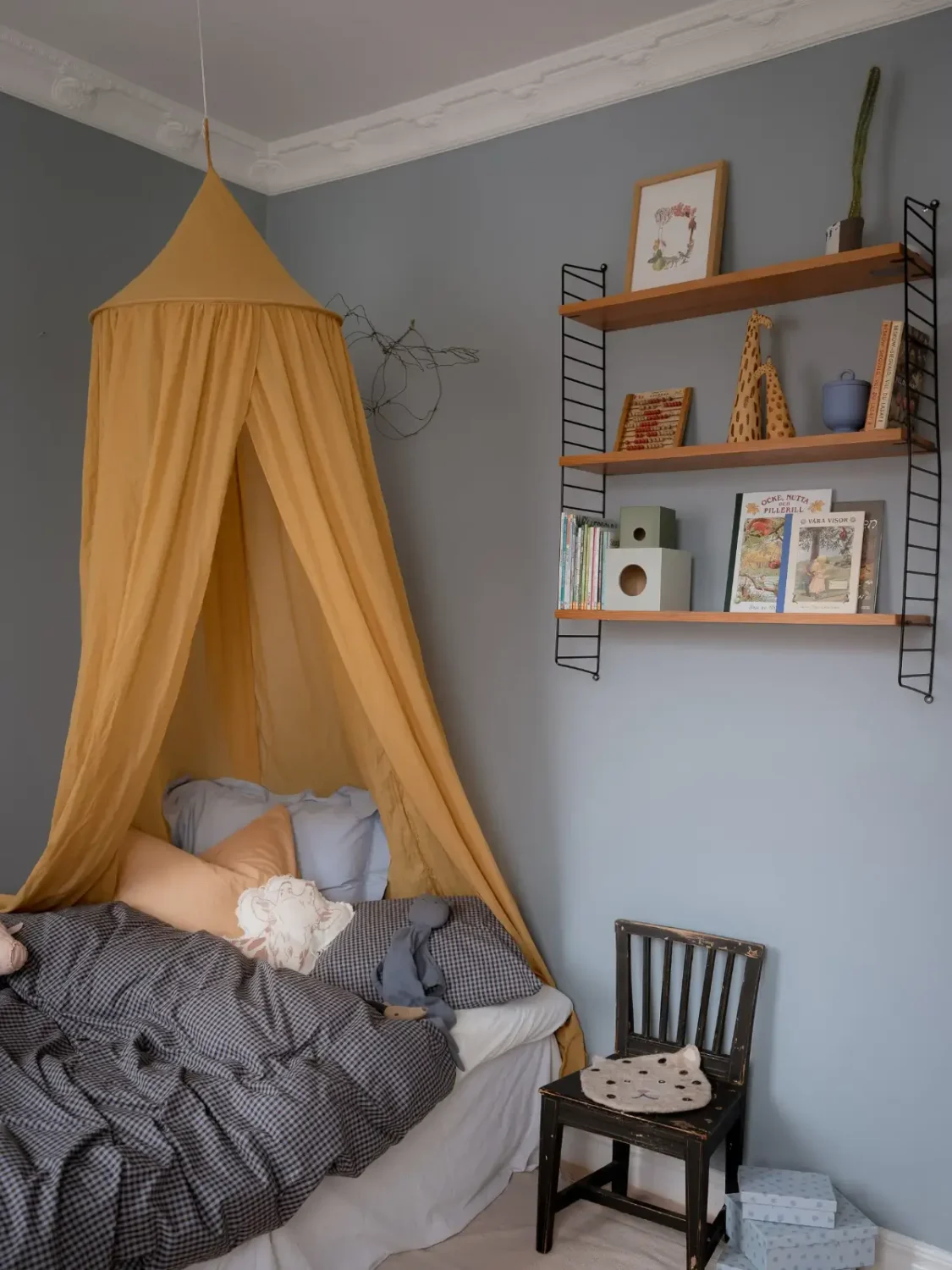 A Cozy Apartment with Exposed Brick and Period Details 27 blue kids bedroom yellow canopy