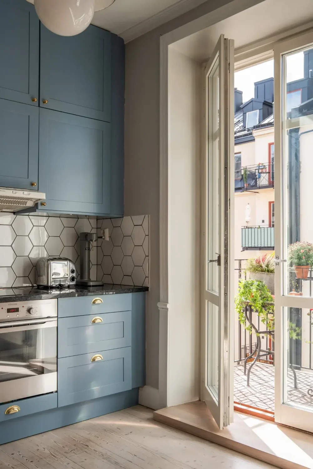 A Light Turn-of-the-Century Apartment with a Blue Kitchen 13 blue kitchen double row of upper cabinets