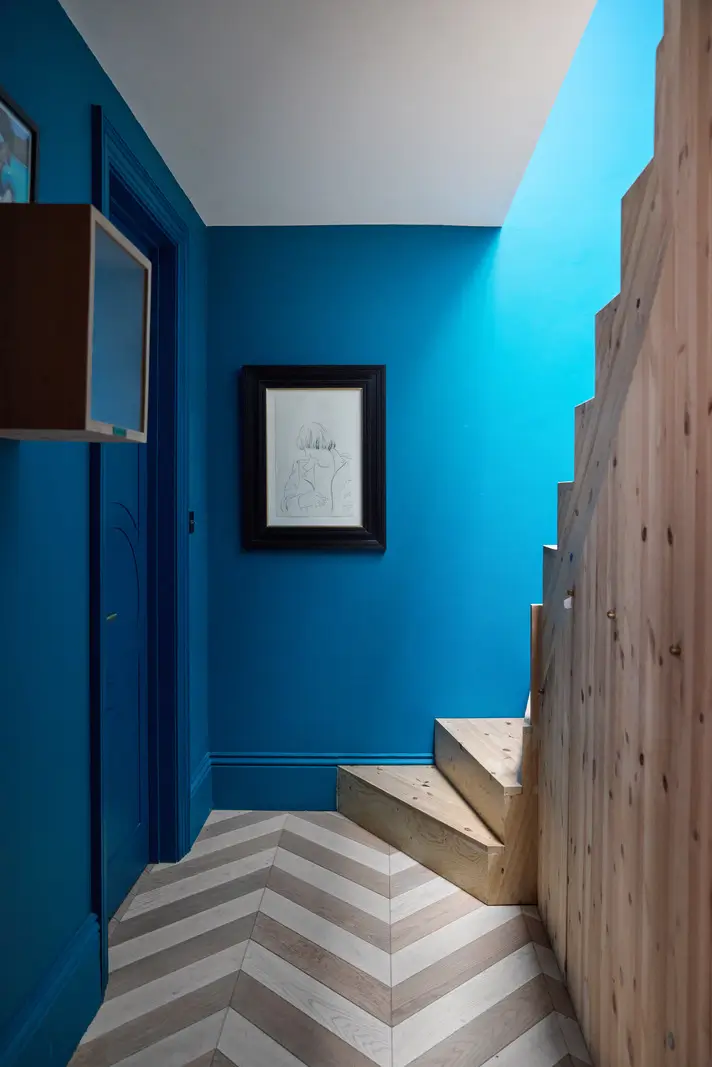 Victorian Grandeur Meets Modern Design in a Camden Square Townhouse 20 blue staircase