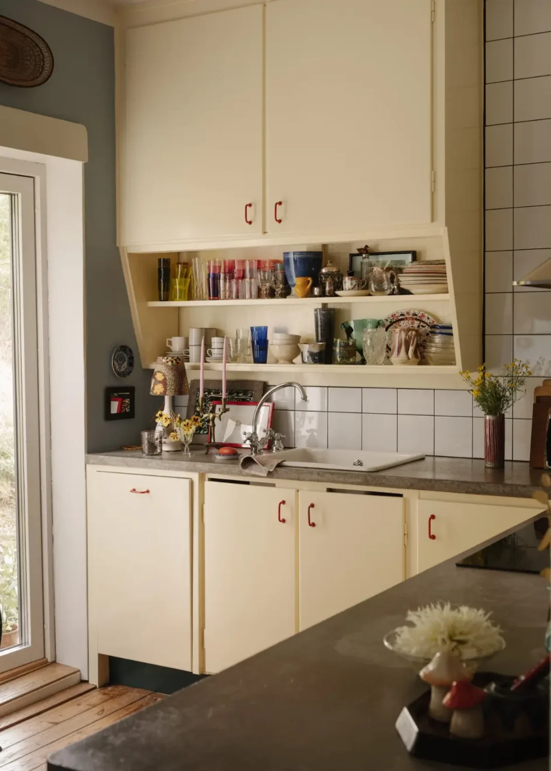 A Pink 1930s Studio Apartment with a Lovely Private Garden 11 butter yellow kitchen cabinets