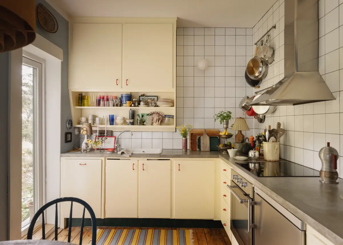 A Pink 1930s Studio Apartment with a Lovely Private Garden 9 butter yellow kitchen white tiles scandi studio apartment