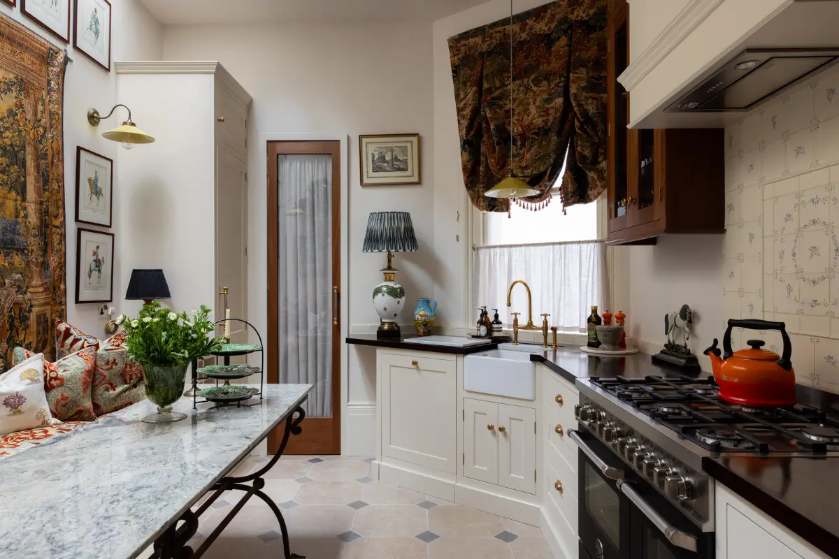 A Mixture of Patterns, Colors, and Materials in a Stunning London Apartment 8 classic kitchen white cabinets butler sink oak countertop hand-painted backsplash tiles