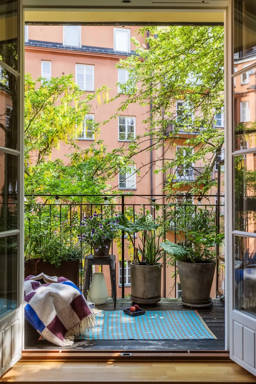 A Charming Swedish Courtyard Apartment Filled with Art 6 courtyard balcony with plants