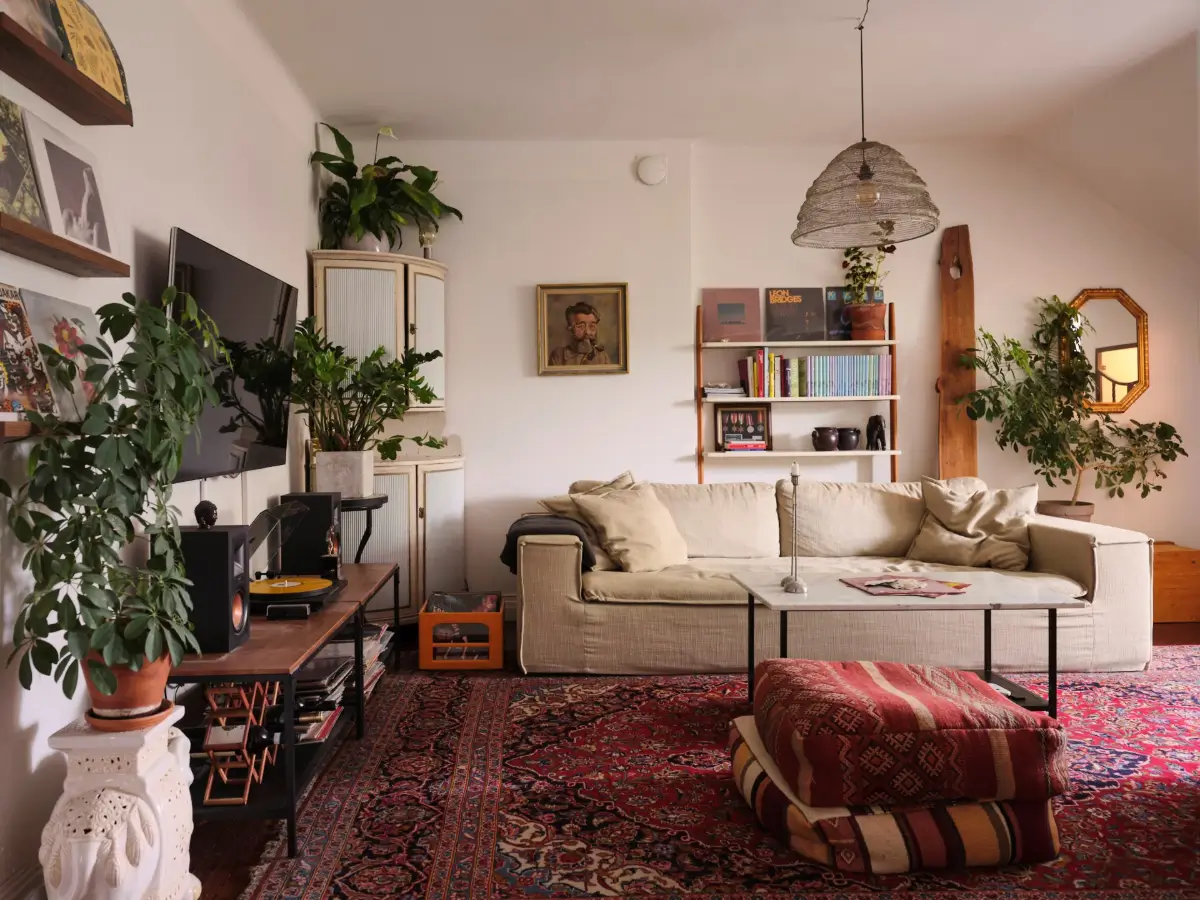 Exposed Beams and Dark-Stained Floorboards in a Cozy Attic Apartment 2 cozy living room large rug plants