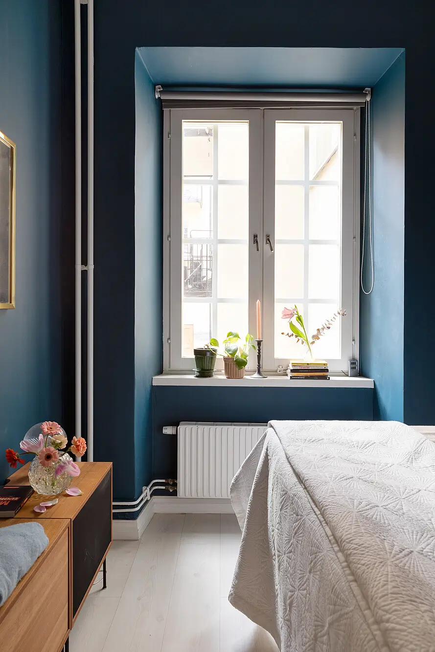 Red and Blue Color Accents in an Open-Plan Stockholm Apartment 15 dark blue bedroom deep window niche