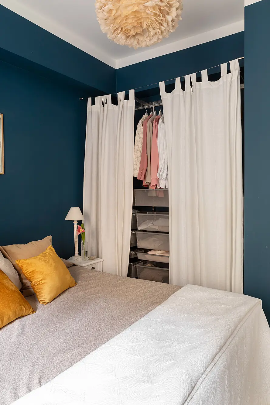 Red and Blue Color Accents in an Open-Plan Stockholm Apartment 16 dark blue bedroom wardrobes behind white curtains