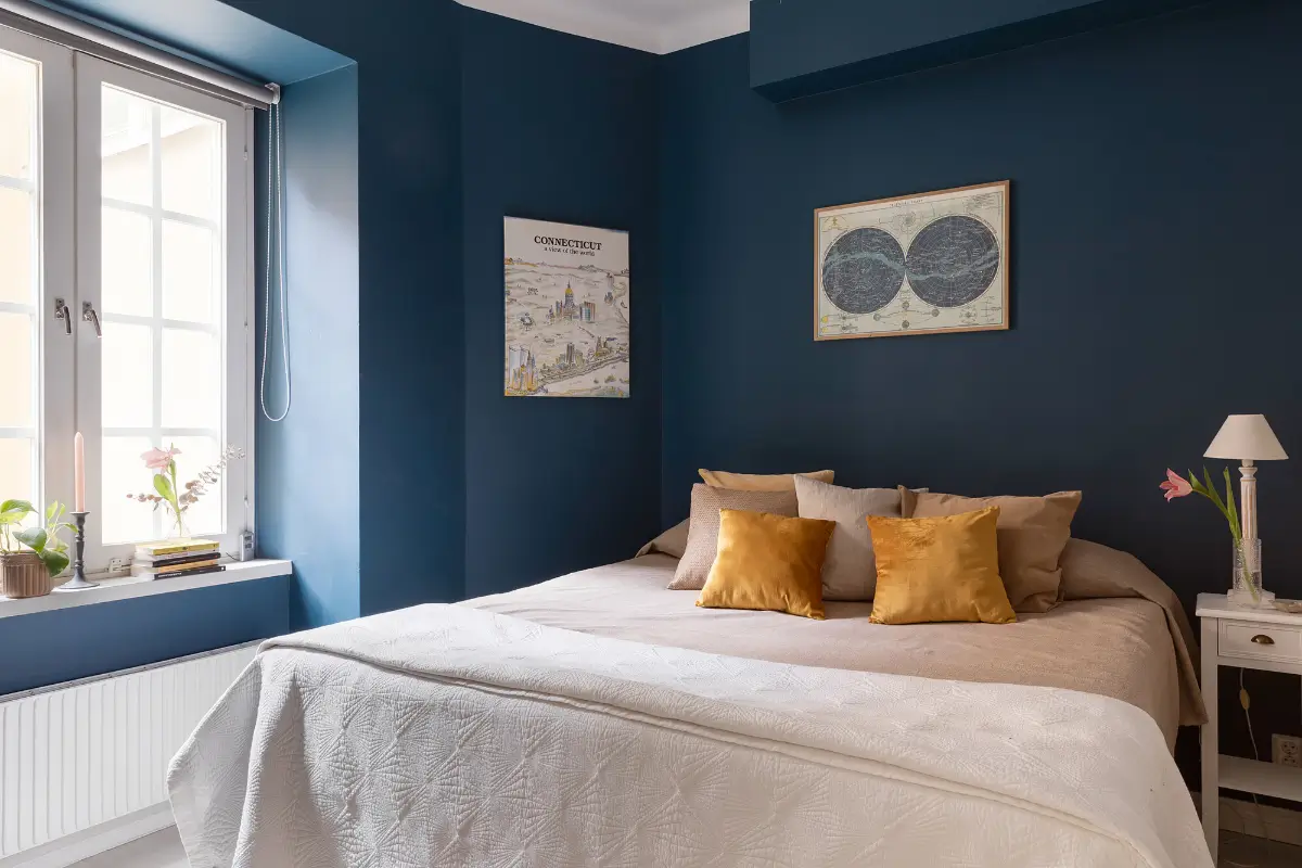 Red and Blue Color Accents in an Open-Plan Stockholm Apartment 14 dark blue bedroom