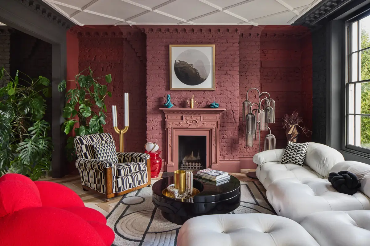 Victorian Grandeur Meets Modern Design in a Camden Square Townhouse 9 dark pink sitting room fireplace white sofa