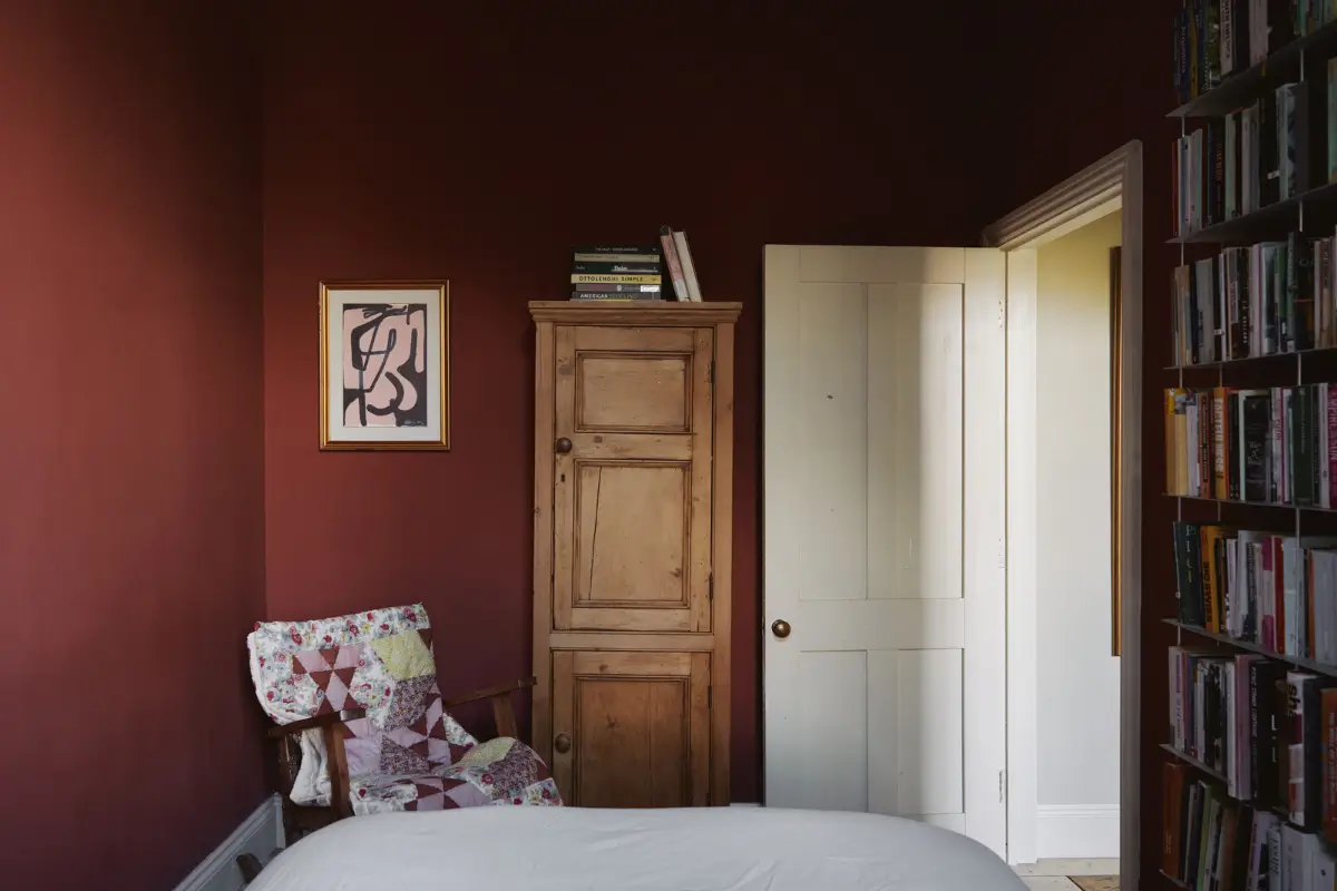 Restored Features in a Charming Georgian Apartment in London 17 dark red color-drenched bedroom