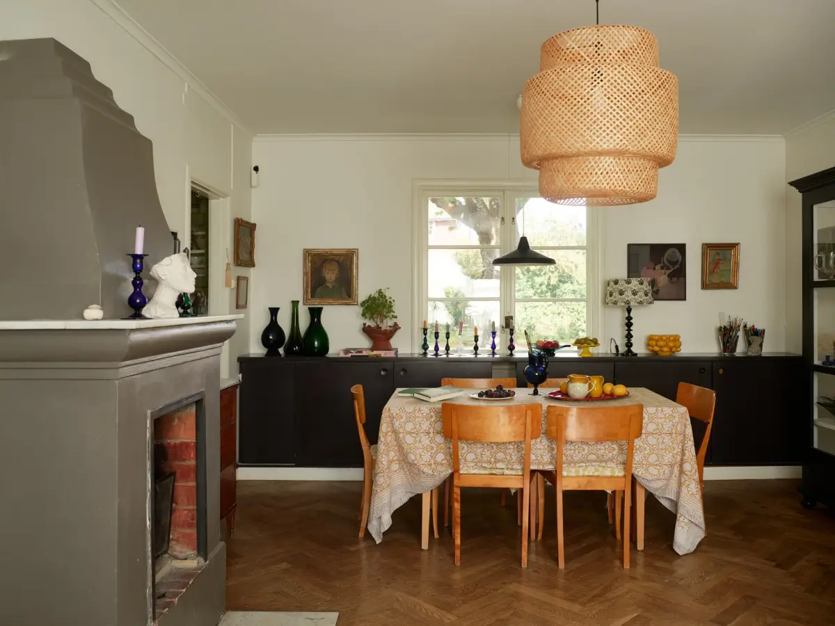 A Well-Preserved 1920s House with a Green Kitchen in Stockholm 8 dining area gray fireplace