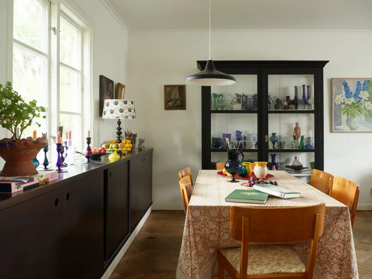 A Well-Preserved 1920s House with a Green Kitchen in Stockholm 9 dining table black built-in cabinets