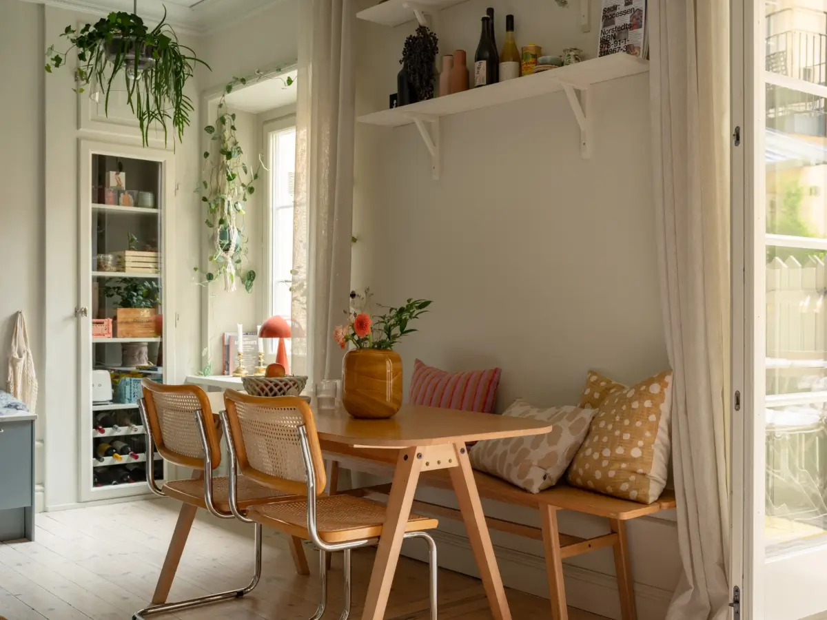 A Light Color Palette and a Charming Private Patio in a Stockholm Apartment 13 dining table with bench