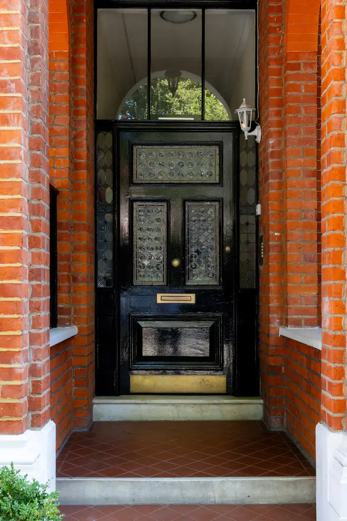 A Mixture of Patterns, Colors, and Materials in a Stunning London Apartment 24 front door
