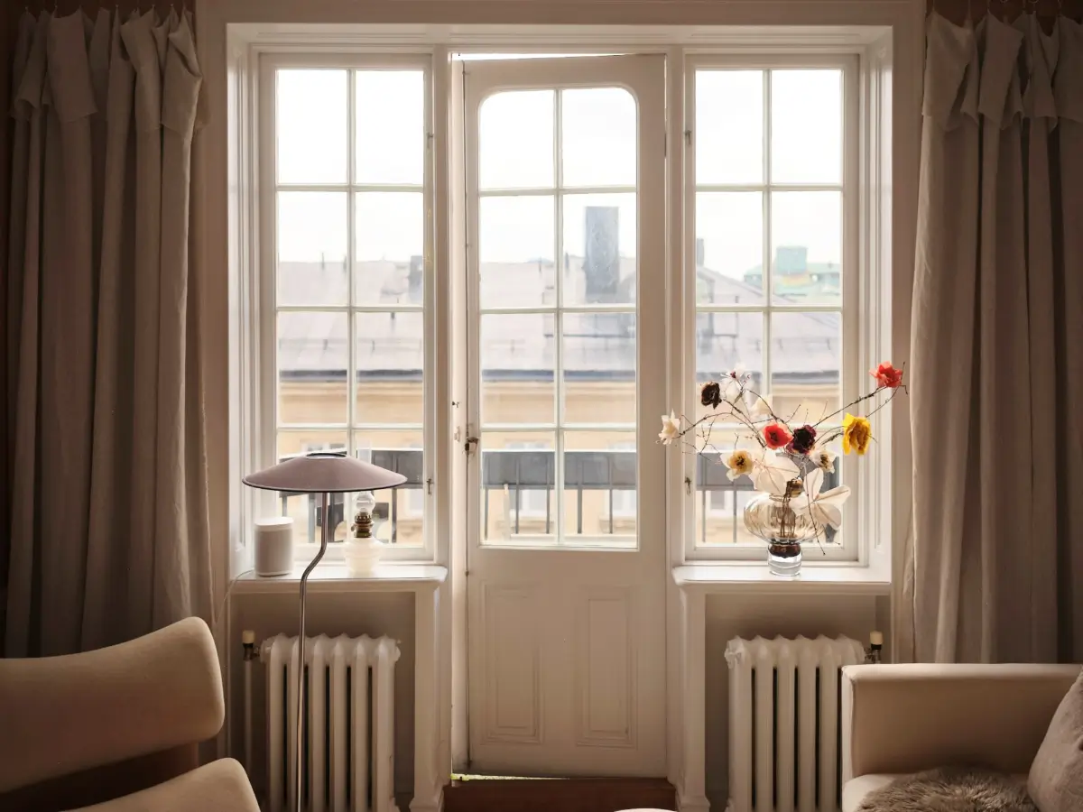 Warm Pink Walls and a Glass Room Divider in a Small Stockholm Apartment 10 glass balcony door