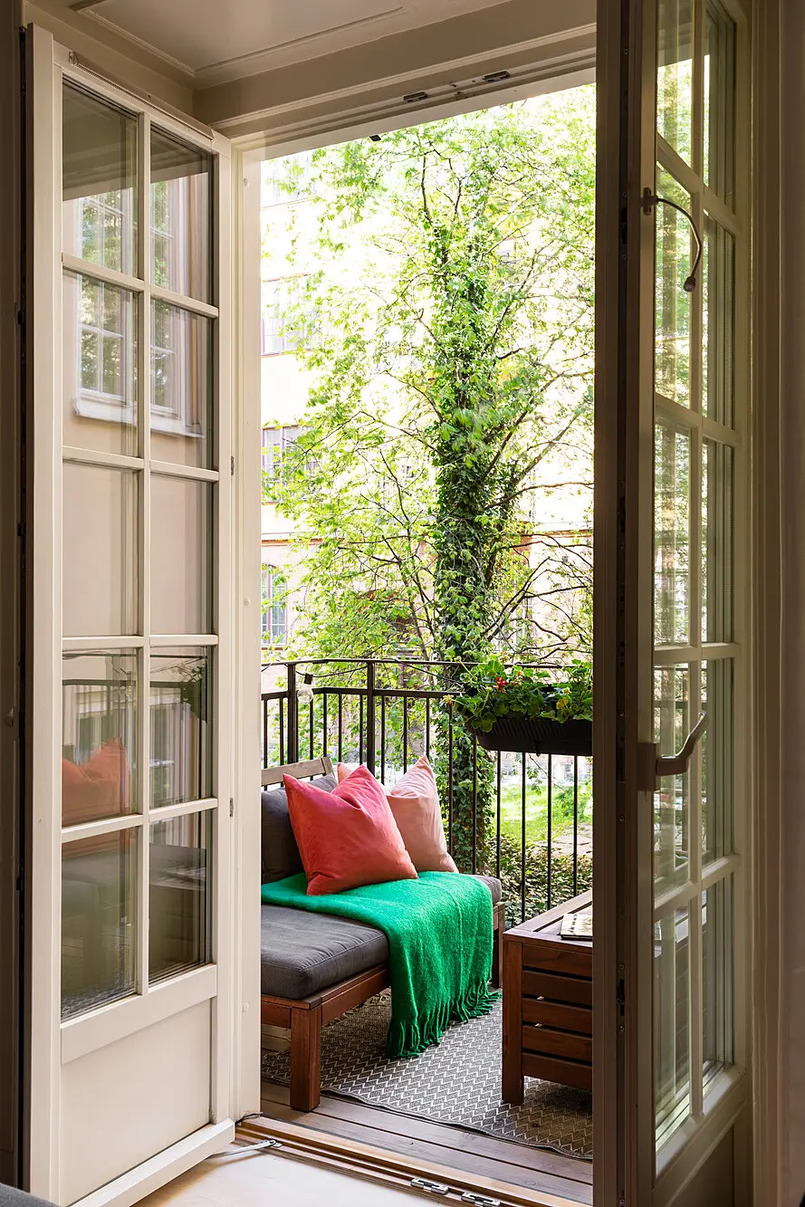 Red and Blue Color Accents in an Open-Plan Stockholm Apartment 5 glass balcony doors