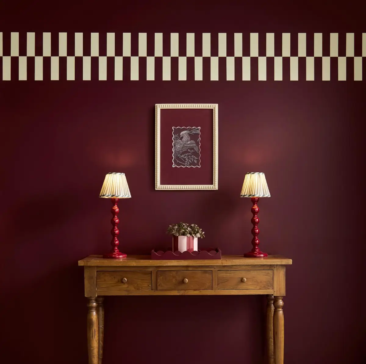 Divine Damson wall paint with checker frieze and warm wood console table