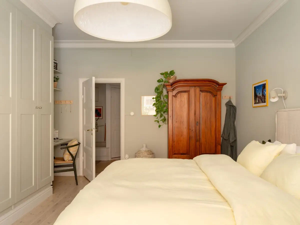 A Light Color Palette and a Charming Private Patio in a Stockholm Apartment 24 gray bedroom antique wardrobe