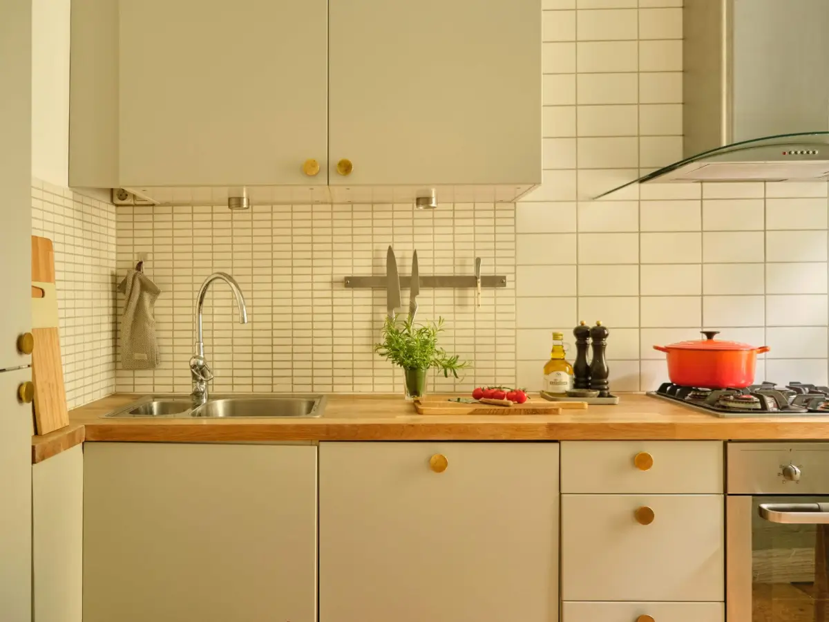 A Lush Balcony and Charming Rooms in a Late 19th Century Apartment 19 gray-green kitchen cabinets wooden countertop