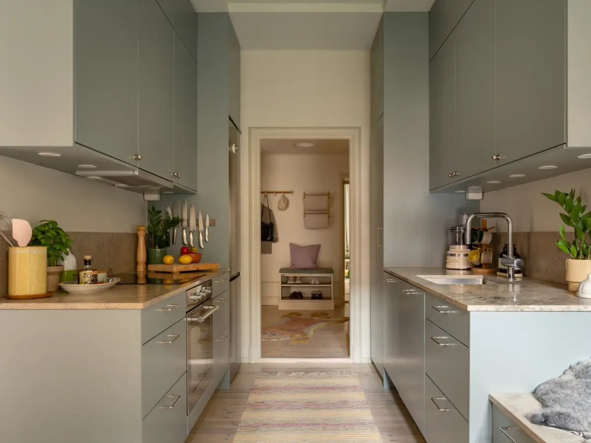 A Light Color Palette and a Charming Private Patio in a Stockholm Apartment 19 gray kitchen high cabinets