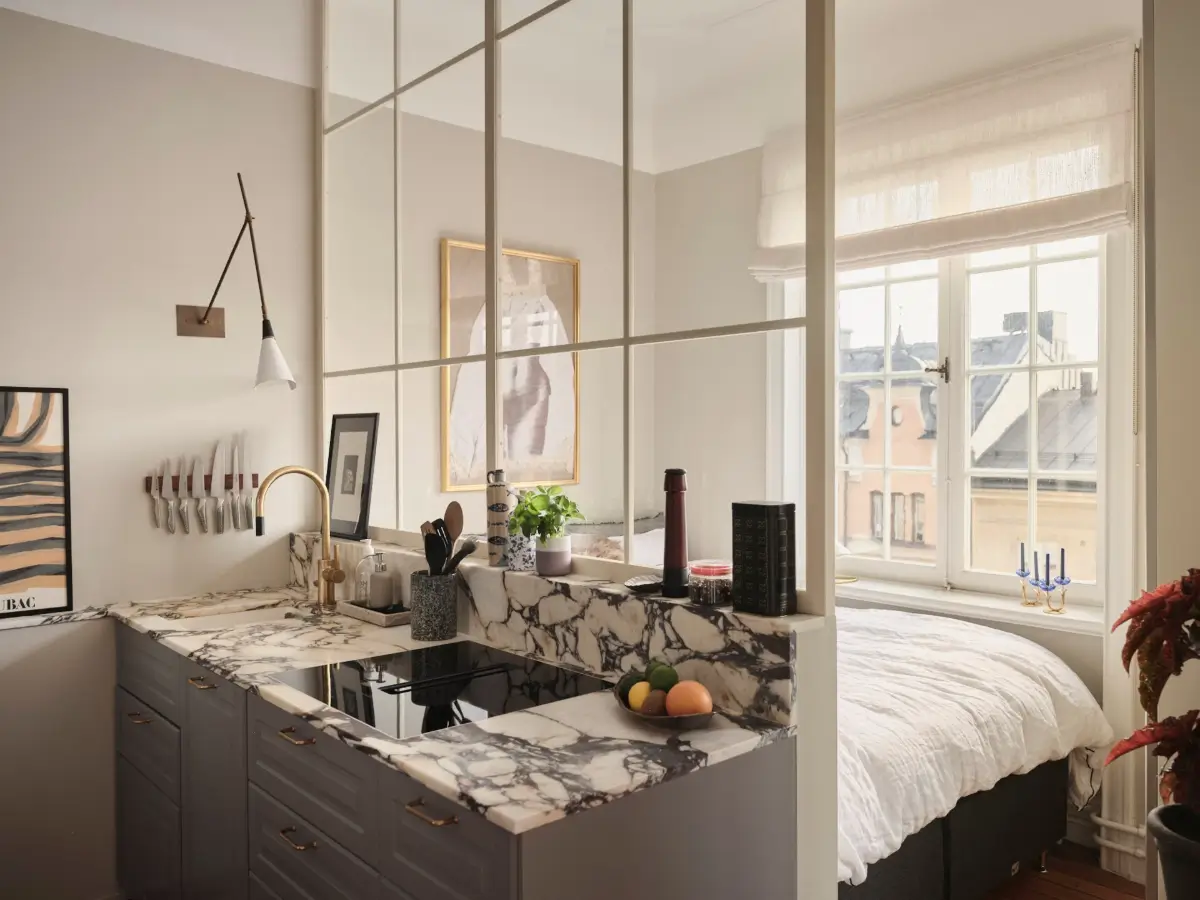 Warm Pink Walls and a Glass Room Divider in a Small Stockholm Apartment 22 gray kitchen marble countertop inner window with bedroom nordroom