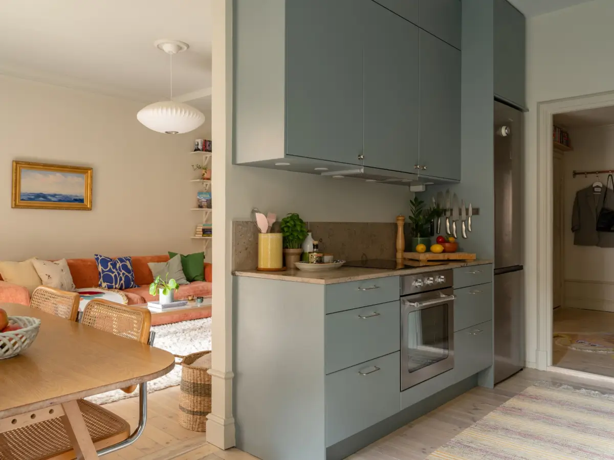 A Light Color Palette and a Charming Private Patio in a Stockholm Apartment 16 gray kitchen semi open layout
