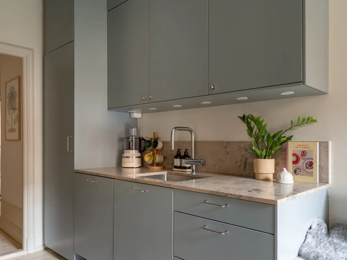 A Light Color Palette and a Charming Private Patio in a Stockholm Apartment 18 gray kitchen