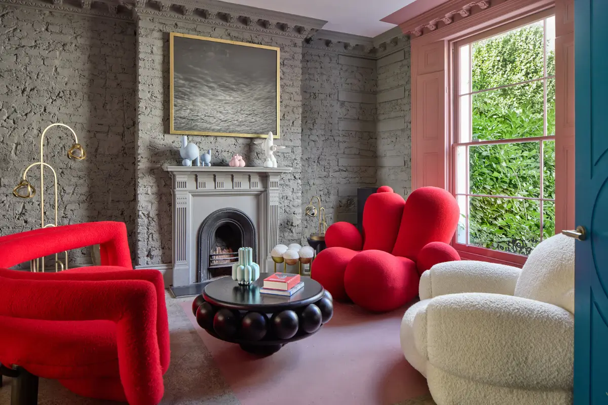 Victorian Grandeur Meets Modern Design in a Camden Square Townhouse 1 gray sitting room red chairs