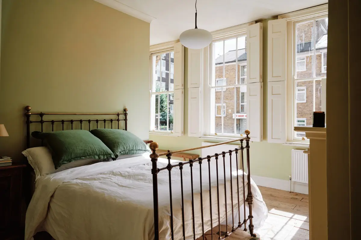 Restored Features in a Charming Georgian Apartment in London 11 green bedroom large windows with shutters