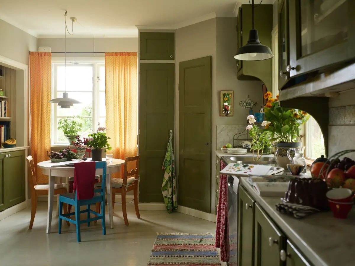 A Well-Preserved 1920s House with a Green Kitchen in Stockholm 1 green kitchen with round table
