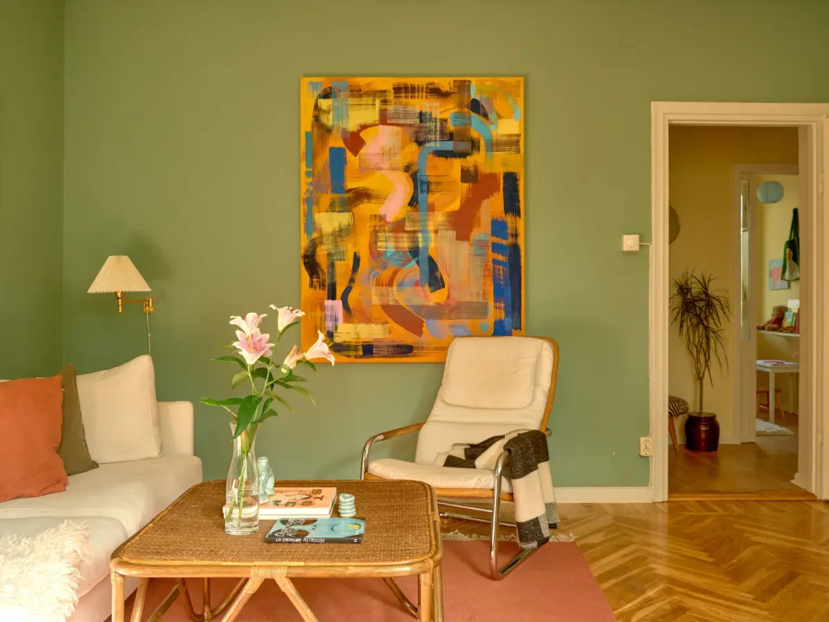 A Colorful and Cozy Midcentury Apartment in Stockholm 9 green living room herringbone floor