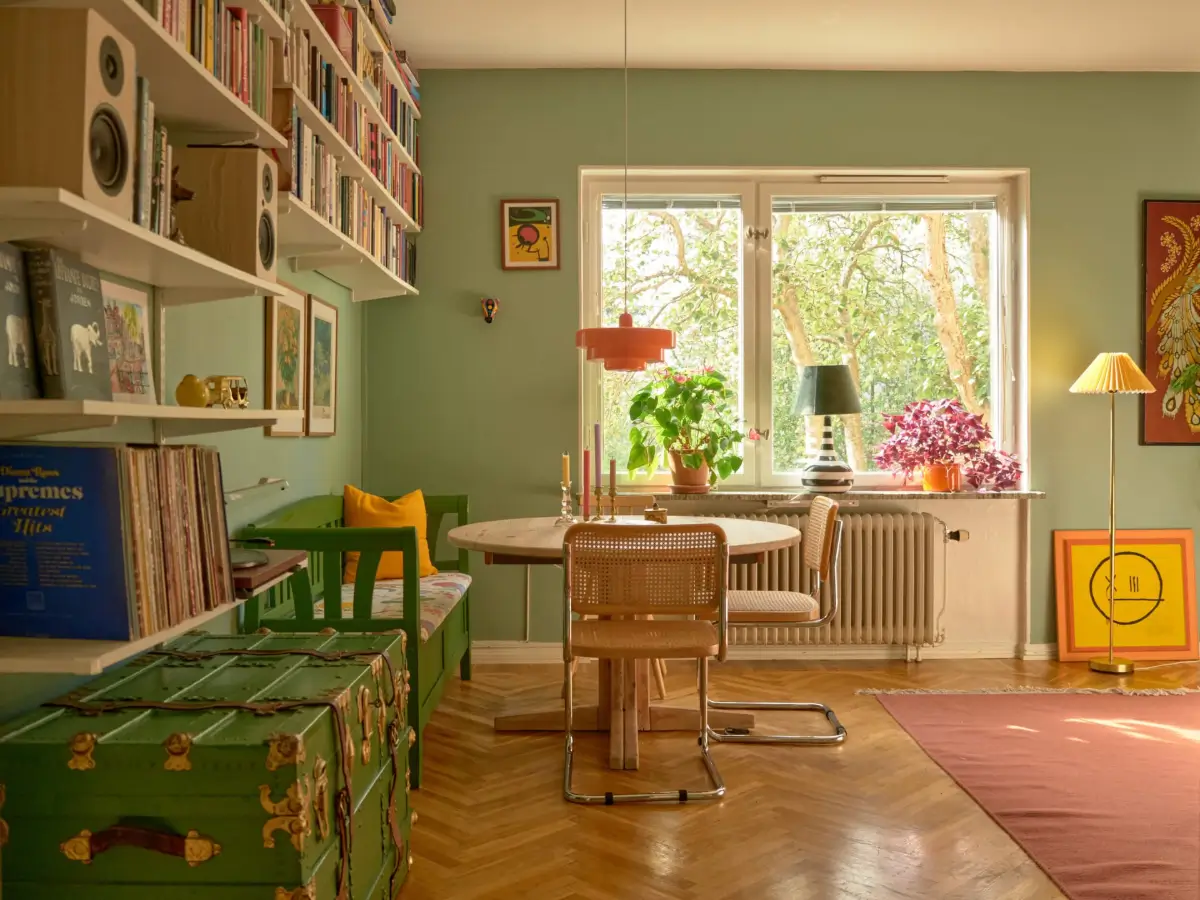 A Colorful and Cozy Midcentury Apartment in Stockholm 8 green living room round wooden table
