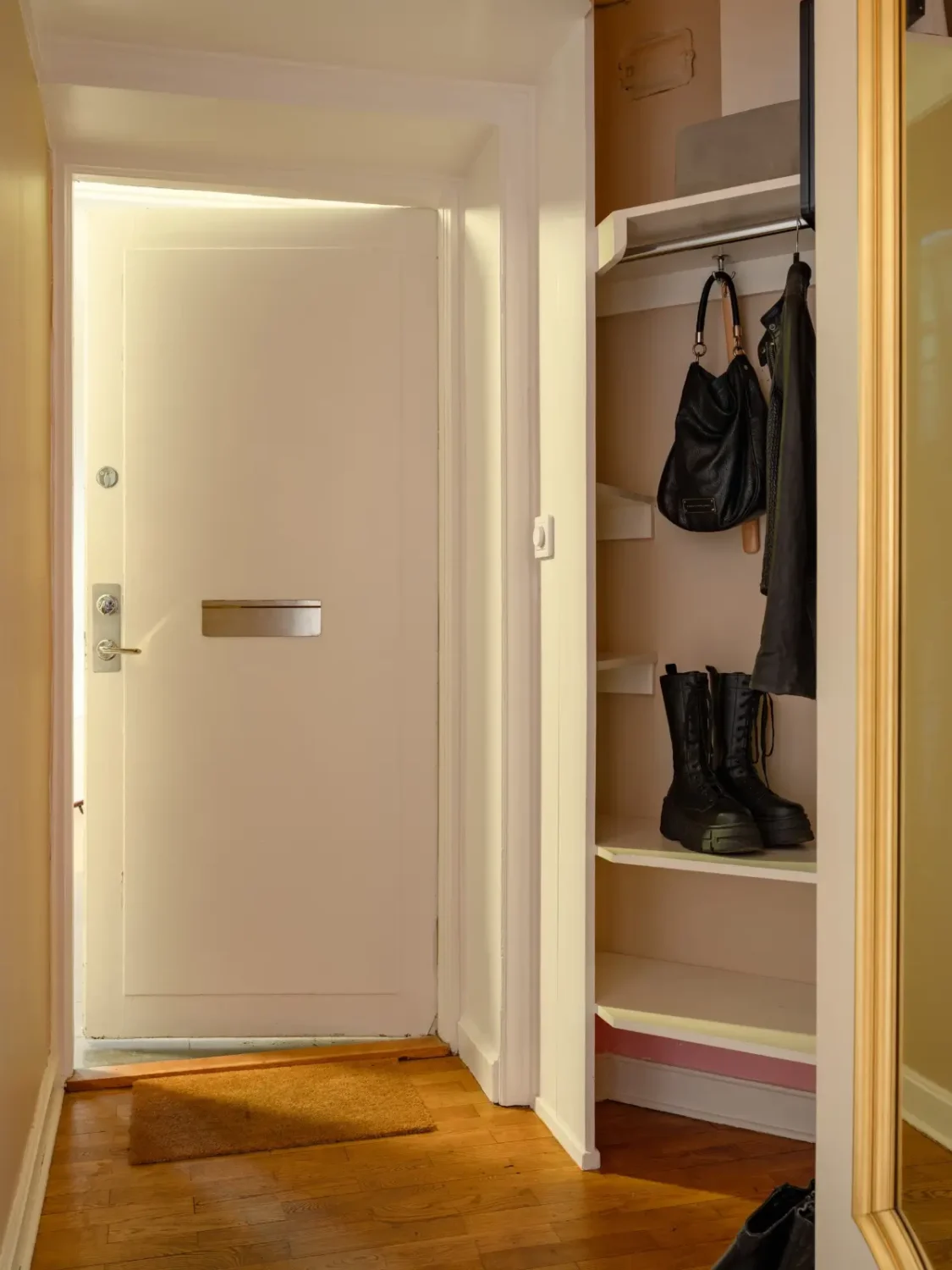 Warm Beige Walls and Practical Niches in a 1920s Studio Apartment 16 hall
