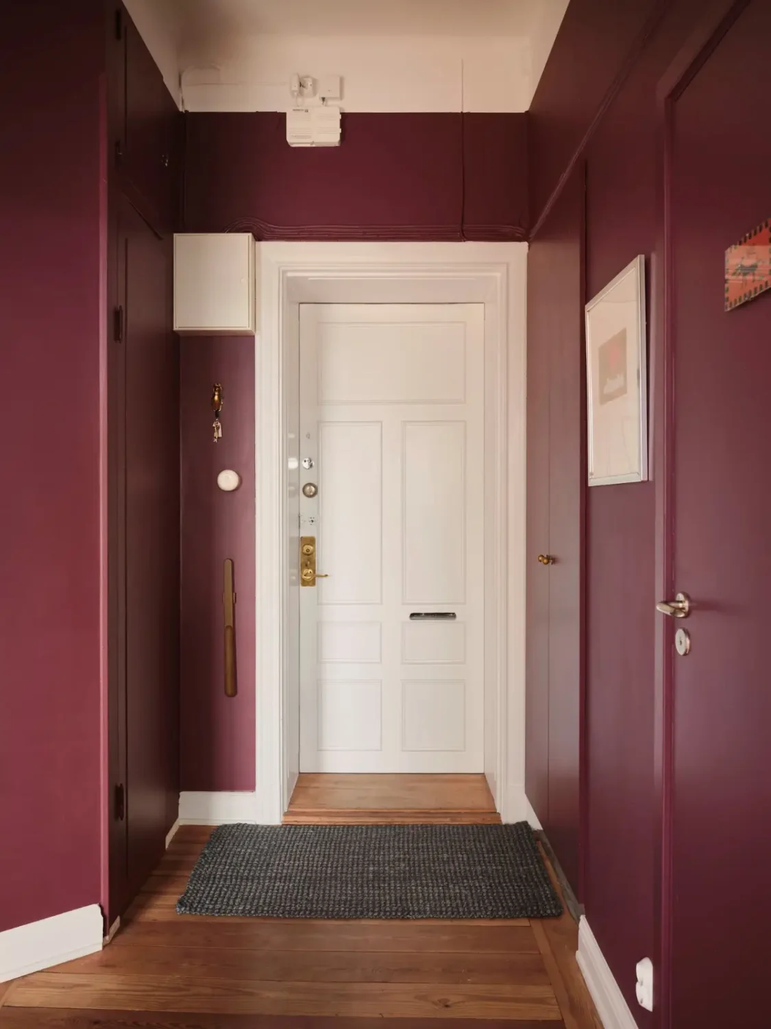 Warm Pink Walls and a Glass Room Divider in a Small Stockholm Apartment 29 hall aubergine wall color Warm Pink Walls and a Glass Room Divider in a Small Stockholm Apartment