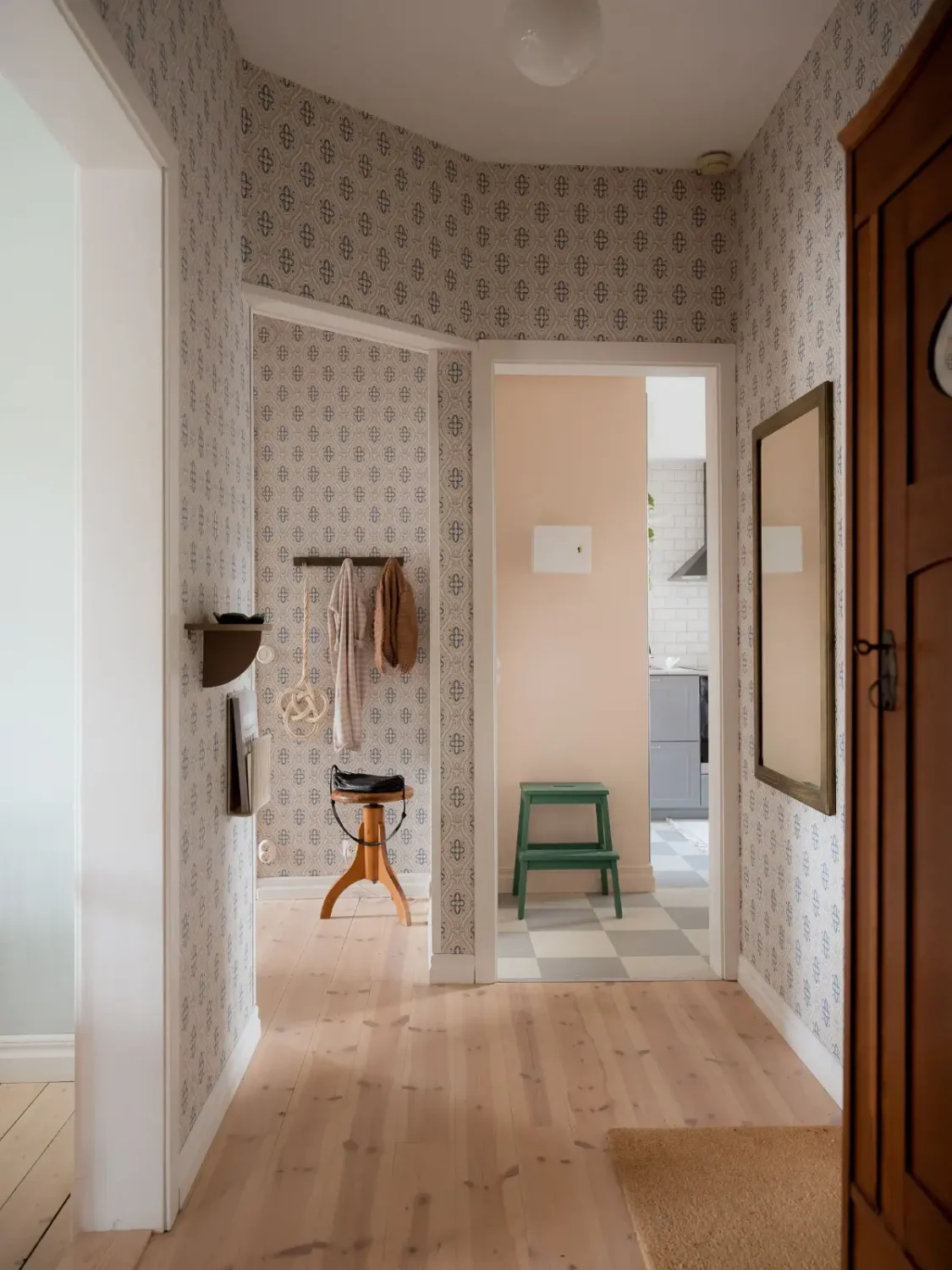 A Cozy Apartment with Exposed Brick and Period Details 24 hall blue wallpaper wooden floor