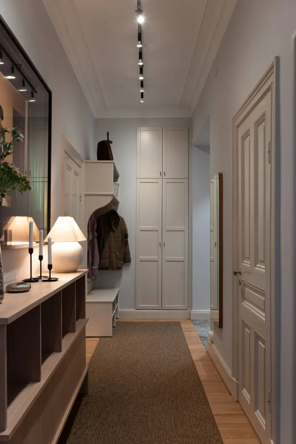 A Luxurious Family Apartment with a Dramatic Black Bathroom 33 hall built-in storage