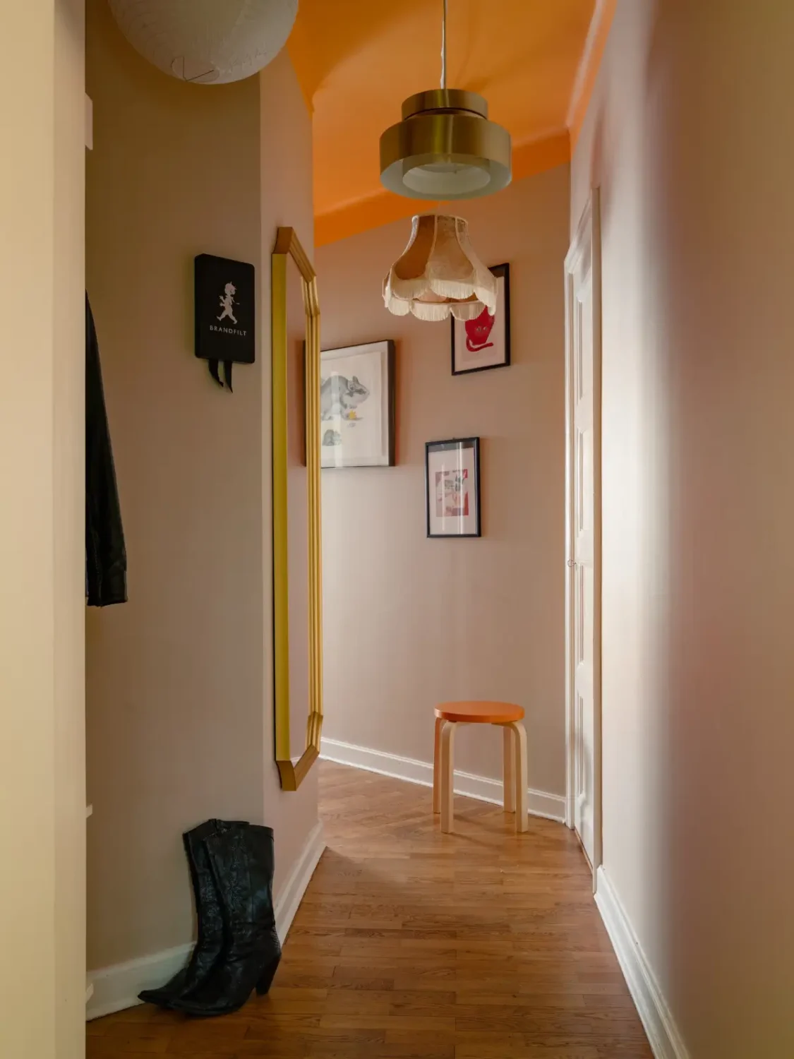 Warm Beige Walls and Practical Niches in a 1920s Studio Apartment 15 hall orange painted ceiling