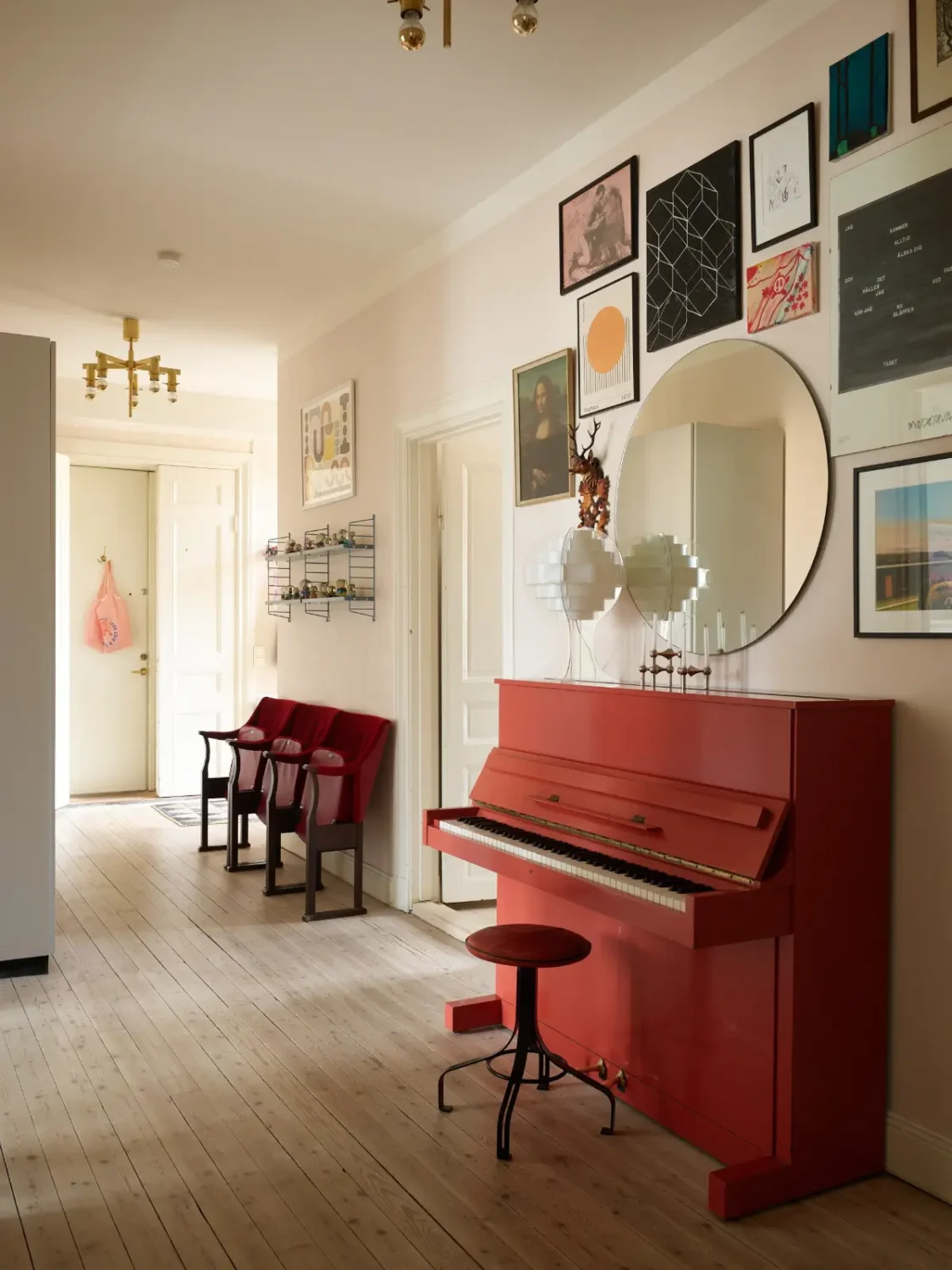 A Spacious Family Apartment with Original Details in Stockholm 12 hall with red piano